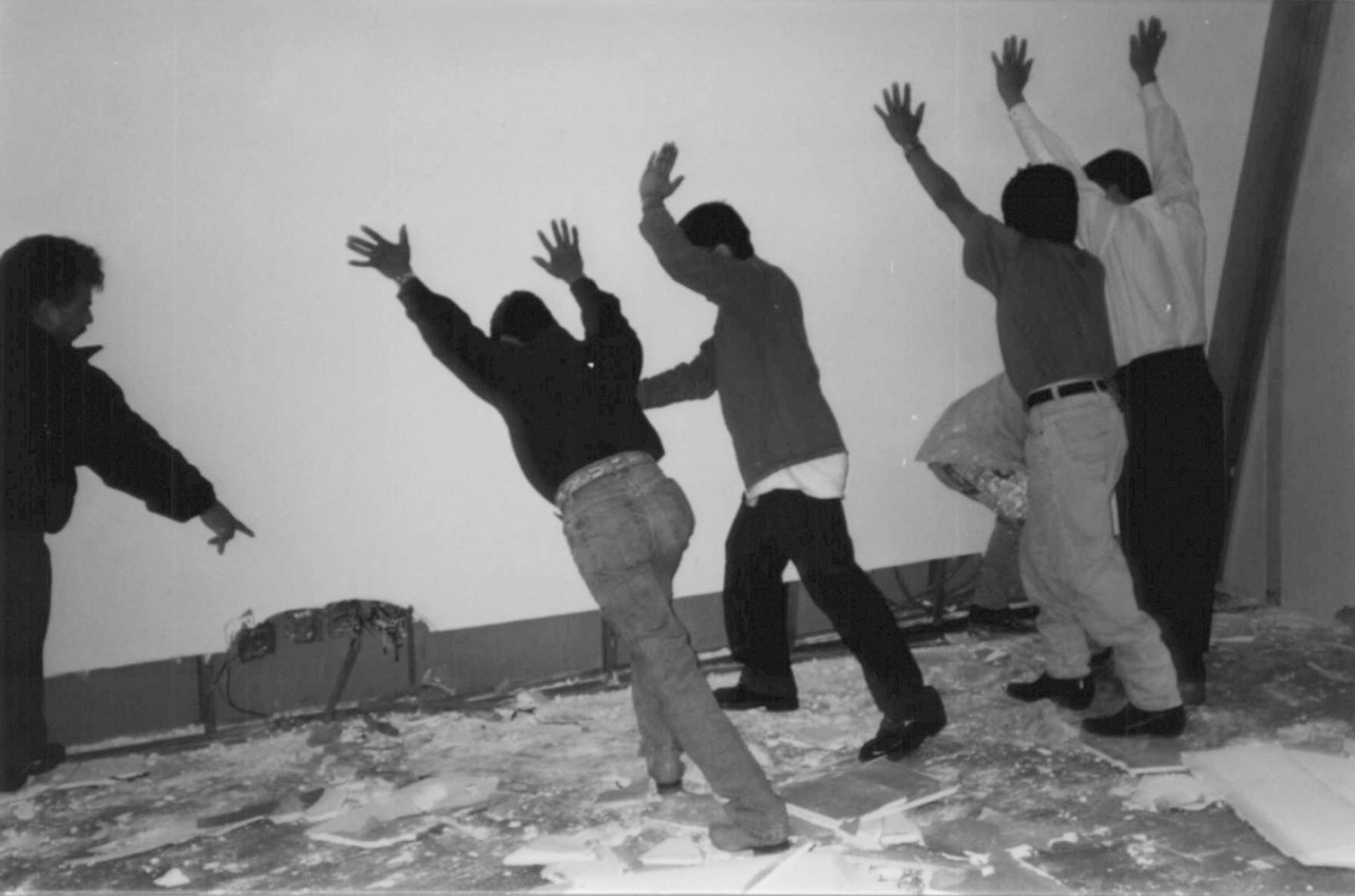 Santiago Sierra, “The Wall of a Gallery Pulled Out, Inclined 60 Degrees from the Ground and Sustained By 5 People,” 2000